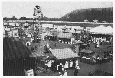 (Image: Midway Tents and Rides next to the Racetrack)