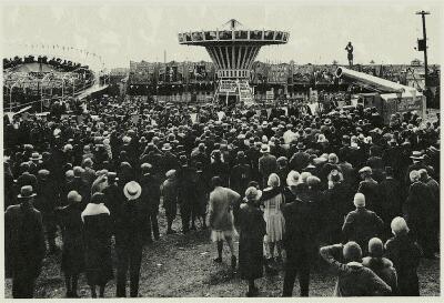 (Image: Midway with Rides, Side Show Tents and Cannon Shot)