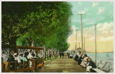(Image: The Train passes by People seated on Benches)