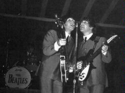 (Image: Paul and John at the Mic on Stage at Empire Stadium)
